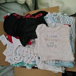 New boxes of boys cloths , diapers , bottles ,